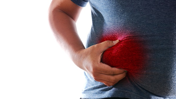 Man holding onto right side of the brightly color in red area symbolizing pain in the liver.